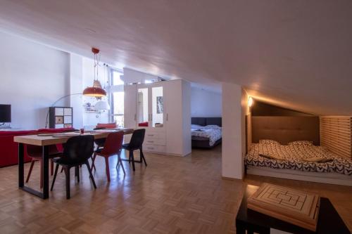 a living room with a dining room table and a bed at Bright loft near Bohinj lake in Bohinj