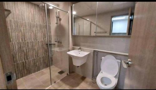 a bathroom with a toilet and a sink and a shower at Condo in Clark Pampanga beside Hilton Hotel and Casino in Fort Stotsenburg
