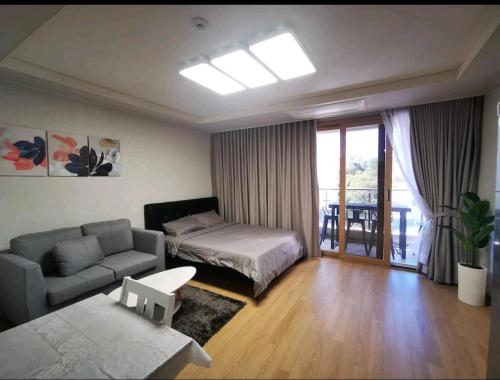 a living room with a bed and a couch at Condo in Clark Pampanga beside Hilton Hotel and Casino in Fort Stotsenburg
