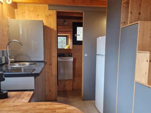 La cuisine est équipée d'un évier et d'un réfrigérateur. dans l'établissement Tiny House Loule Algarve, à Loulé