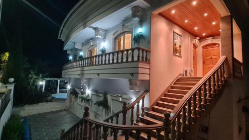 a house with a staircase leading up to it at night at Silver Coast Village in Maceira