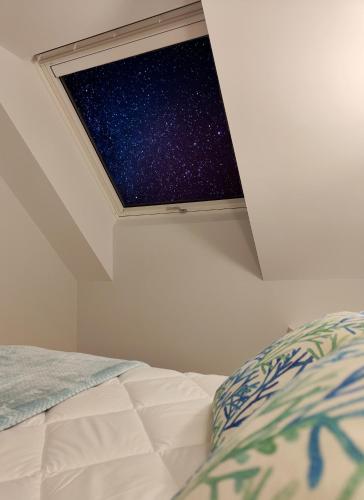 a bedroom with a window with a starry sky at Apartamentos Centro Oviedo Caveda in Oviedo