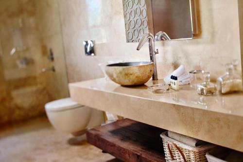 a bathroom with a sink and a toilet at Two Rooms Hotel in Urla