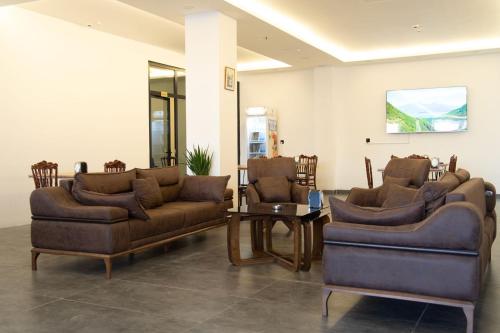 a living room with two couches and a table at Danzha Motel Erbil in Erbil