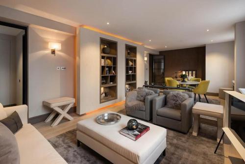 a living room with a couch and a table at Knightsbridge & Chelsea Lux apartments in London