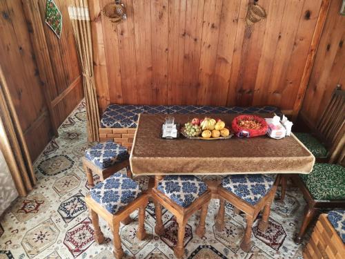 a table with a plate of fruit on top of it at Hb nancy group of houseboats in Srinagar