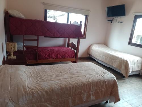 a hotel room with two beds and a window at Cabañas Cafayate III in Cafayate
