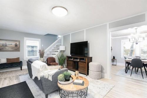 a living room with a couch and a table at South Bend Serenity: Freshly Renovated 3BR 2mi ND in South Bend