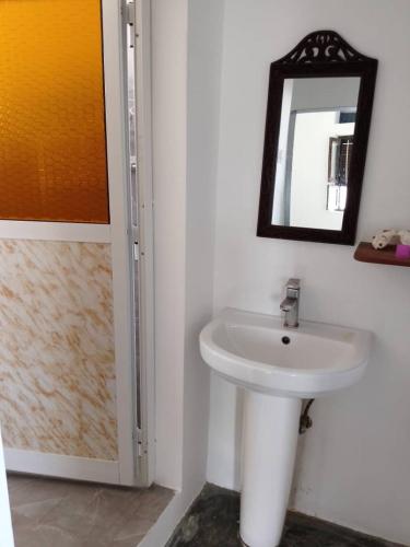 a bathroom with a sink and a mirror at Seafarers Loft in Stone Town
