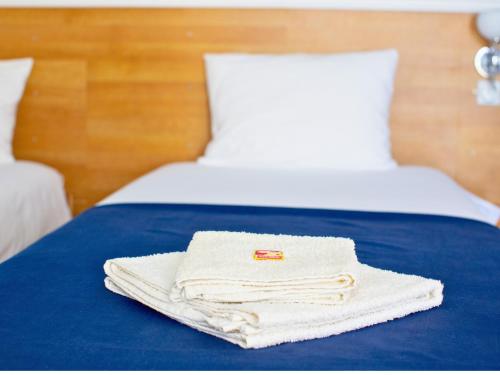 a pile of towels sitting on top of a bed at Villa Saturea in Boljevac