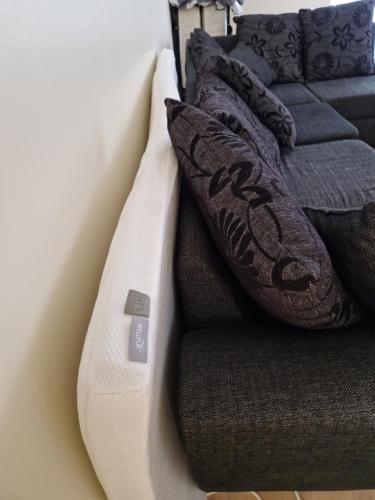 a white couch with pillows on top of it at Padriku Apartment with a balcony,near to central,Self Check In 24 7,FREE Parking in Tallinn