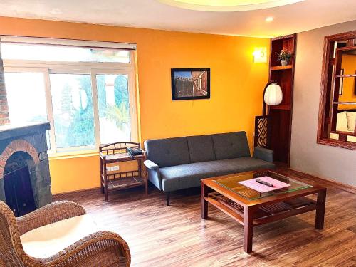 a living room with a couch and a fireplace at Cat Cat View Hotel in Sa Pa