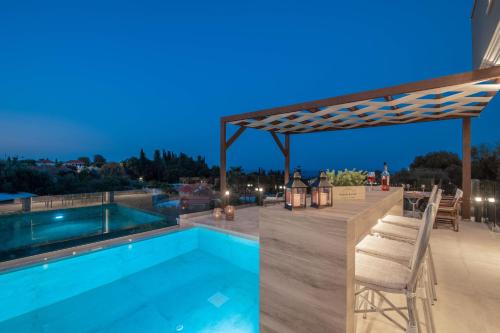 a swimming pool with a pergola on a roof at Lazai Villa in Zakynthos