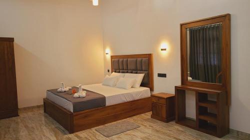a bedroom with a bed with white sheets and a window at Weligama Bay House in Weligama