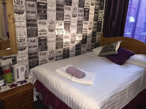 a bed with two pillows on it in a room at Bradleys Hotel in Blackpool