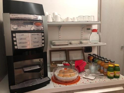 a kitchen with a refrigerator with a cake in it at B&B Nuova Ostiglia in Quinto di Treviso