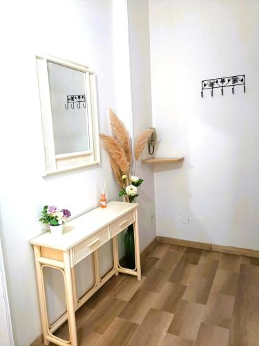 a room with a table and a mirror on a wall at Appartamento Gioia Lugo a 5m da Maria Cecilia Hospital in Lugo