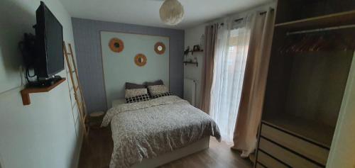 a bedroom with a bed with a face on the wall at Appartement T3 à Saint-Denis in Saint-Denis