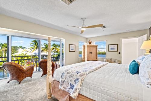 a bedroom with a bed and a balcony at Bayside Escape - 1345 in Siesta Key