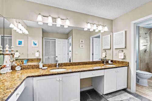 a bathroom with two sinks and a large mirror at Bayside Escape - 1345 in Siesta Key