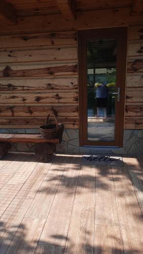 a door to a log cabin with a person in the doorway at Penzion a drevenica pri Hati in Terchová