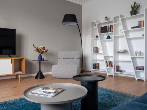 een woonkamer met een tafel en een stoel bij Central Apartment Parking Two Bedrooms Sky Terrace in Sofia