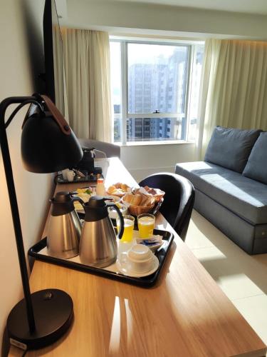 a tray of food on a table in a living room at Tryp by Wyndham Brasília Nações in Brasilia