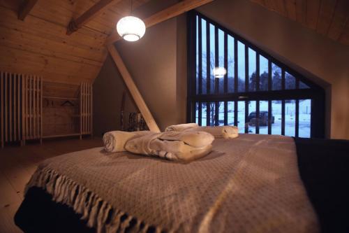 a bed in a room with a large window at PORTAL WYSOWA in Wysowa-Zdrój
