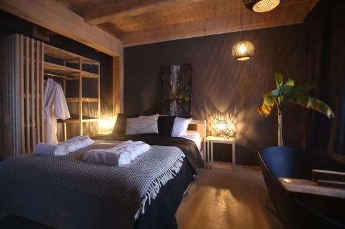 a bedroom with a bed with two towels on it at PORTAL WYSOWA in Wysowa-Zdrój