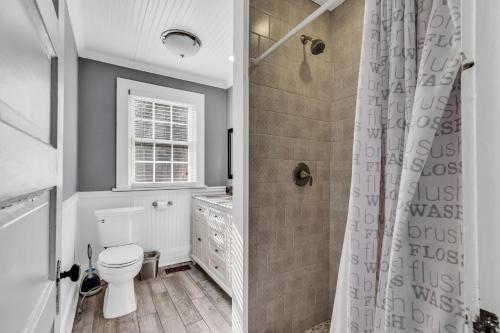 a bathroom with a toilet and a shower at Bright and Modern Close to Everything in Charlotte
