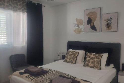 a bedroom with a bed and a chair at Casa Reina Tauro with private pool in La Playa de Tauro