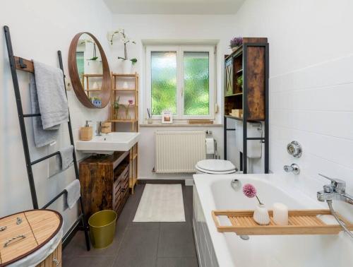 ein Badezimmer mit einer Badewanne und einem Waschbecken in der Unterkunft 2OG Links - Wunderschöne 70m2 2-Zimmer City Wohnung nähe Salzburg in Freilassing