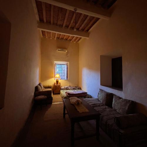 a living room with a couch and a tv at Dar Toda - Zagora guest house in Zagora
