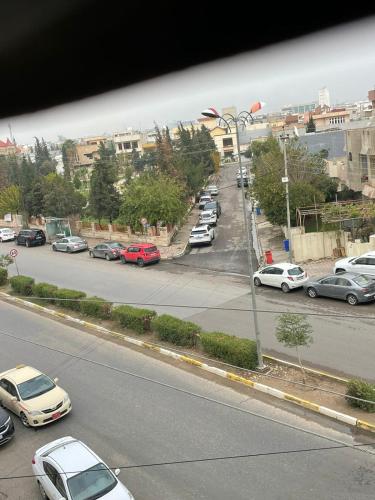 a view of a street with cars parked on the road at Danzha Motel Erbil in Erbil