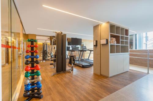 a room with a gym with a bunch of equipment at Ramada by Wyndham Brasilia Alvorada in Brasilia