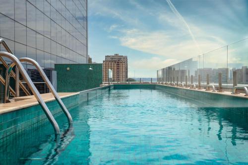 a swimming pool on the roof of a building at Ramada by Wyndham Brasilia Alvorada in Brasilia