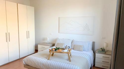 a bedroom with a bed with a table on it at Appartamento incantevole con Piscina in Castiglione del Lago