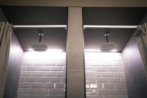 a hallway with two lights on the ceiling at Hostelò - Luxury Hostel in Palermo