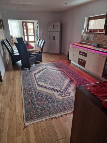 a living room with a table and a rug at Ciprians' Home in Săcele