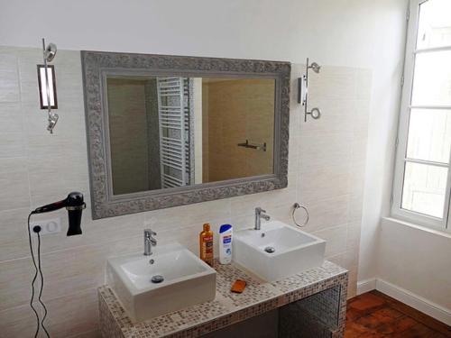 Baño con 2 lavabos y espejo en Le gite des carmes, en Lauzerte