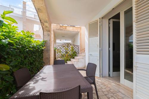 a table and chairs on the patio of a house at Le Piscine RELAX in Nardò