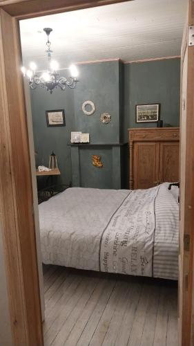 a bedroom with a bed and a chandelier at Dream@coast in Nieuwpoort
