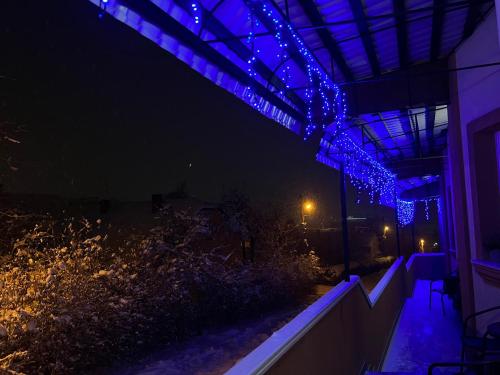 a building with blue lights on it at night at Готель «У Батька» in Truskavets
