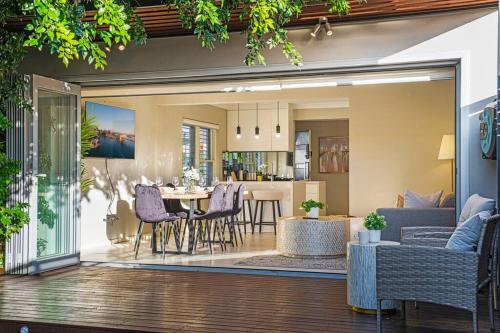 a living room and dining room with a table and chairs at Charming house in Leichhardt in Sydney