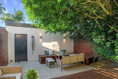 a patio with a table and chairs under a tree at Charming house in Leichhardt in Sydney