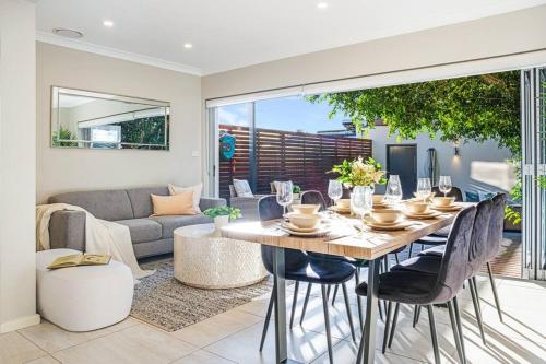 a dining room with a table and a couch at Charming house in Leichhardt in Sydney
