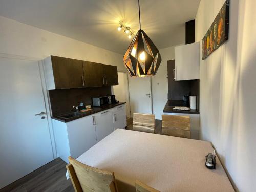 a kitchen with a table and a dining room at Apartments am Mühlbach in Amstetten