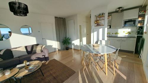 a living room with a couch and a glass table at 9 High (in the Sky) in De Panne
