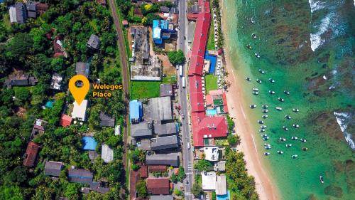 an overhead view of a beach and the ocean at Weleges Place in Hikkaduwa