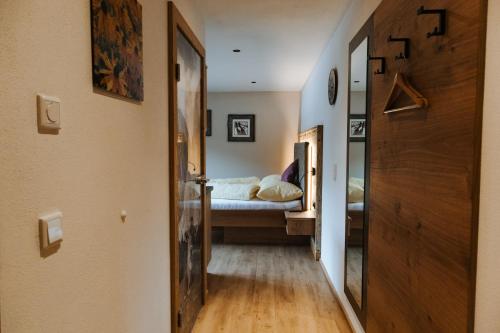 a hallway leading to a bedroom with a bed at Apartments Haufhof , Haus im Ennstal bei Schladming in Haus im Ennstal